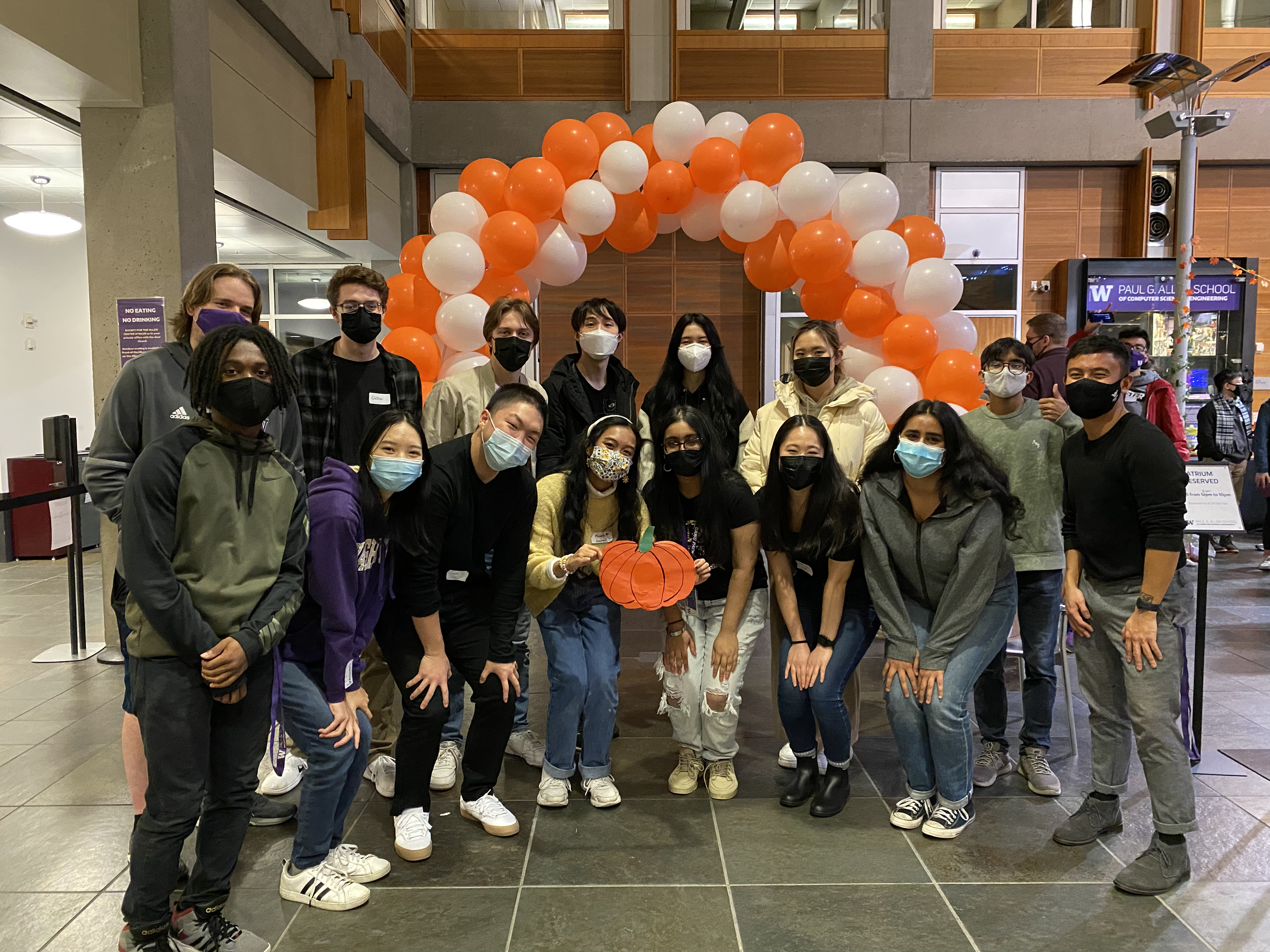 Group photo of ACM officers (2021) in front of a white and orange balloon arch.